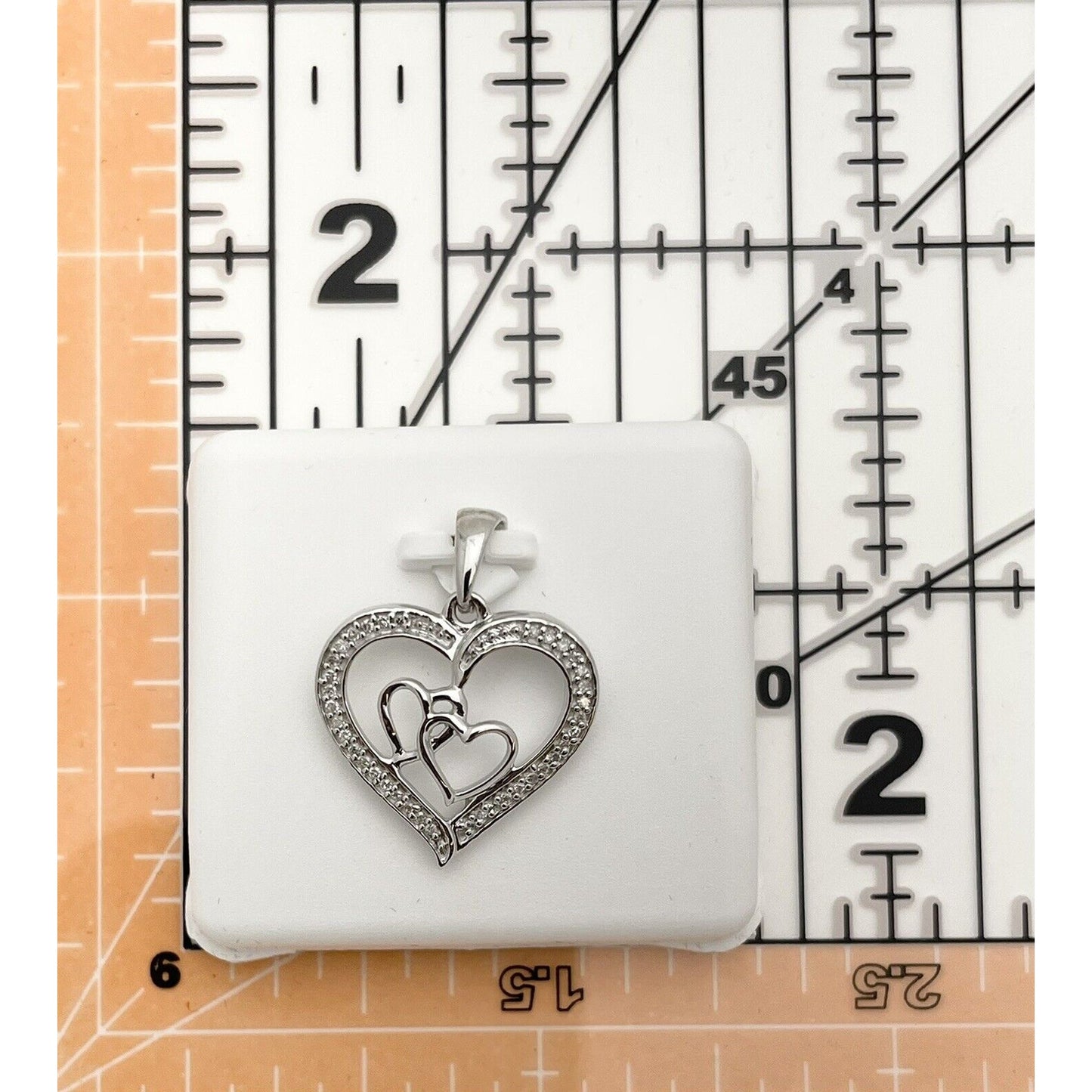 Sterling Silver 1/8 ctw Diamond Triple Heart Pendant 1.728g